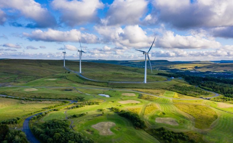Three wind turbines situated in the mid of the English countryside