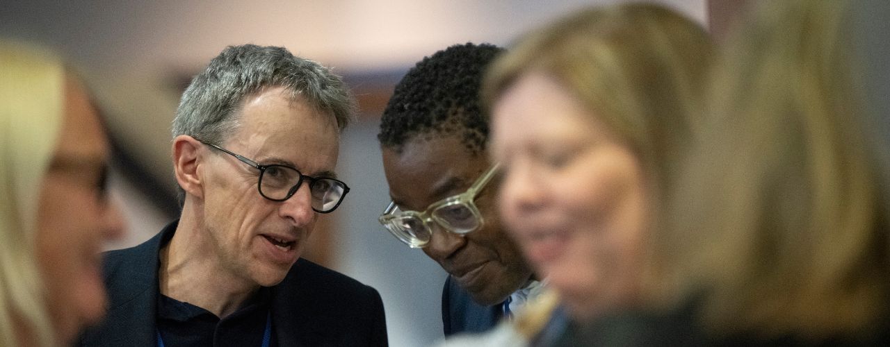 Health Innovation East's CEO, Piers Ricketts, talks with partner at event,