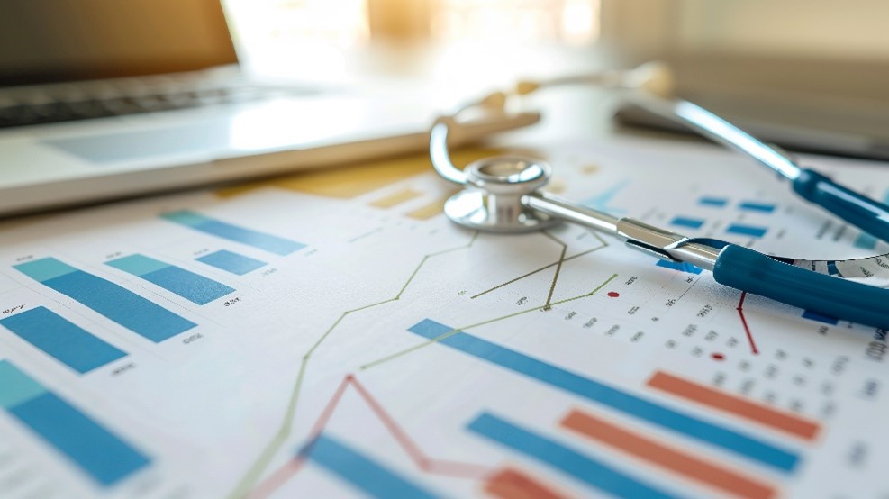 A stethoscope , charts and a computer on a clinicians desk