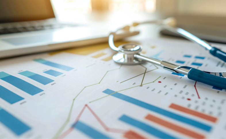 Stethoscope laid across charts and graphs