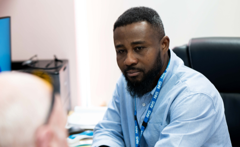 healthcare practitioner, Benson, talks with patient