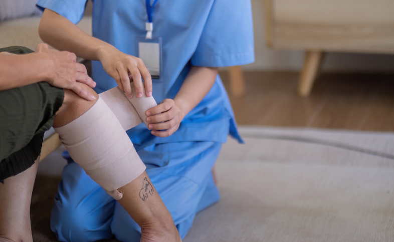 Nurse wraps patients leg wound