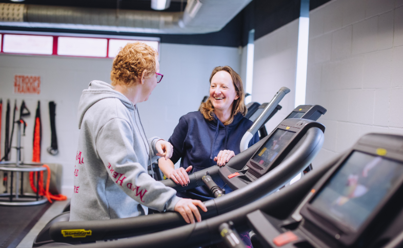 Michelle works out on the treadmill while talking to her training Lisa