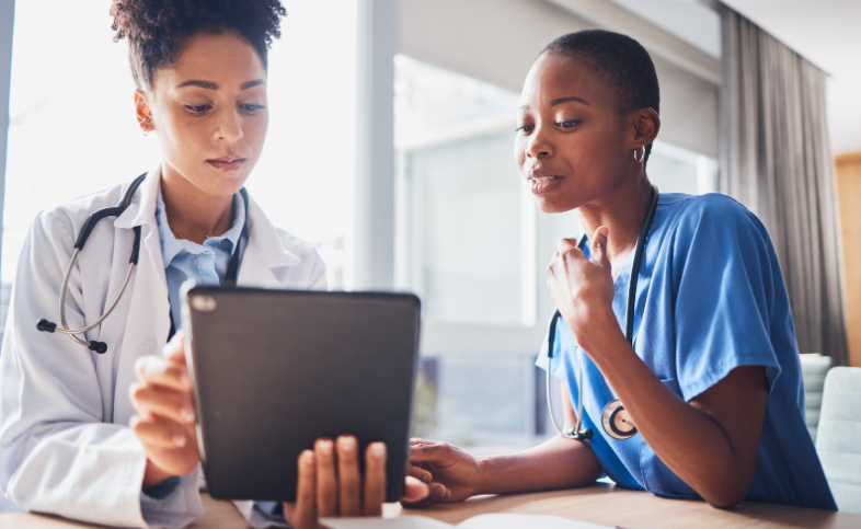 Two clinicians looking at an Ipad together