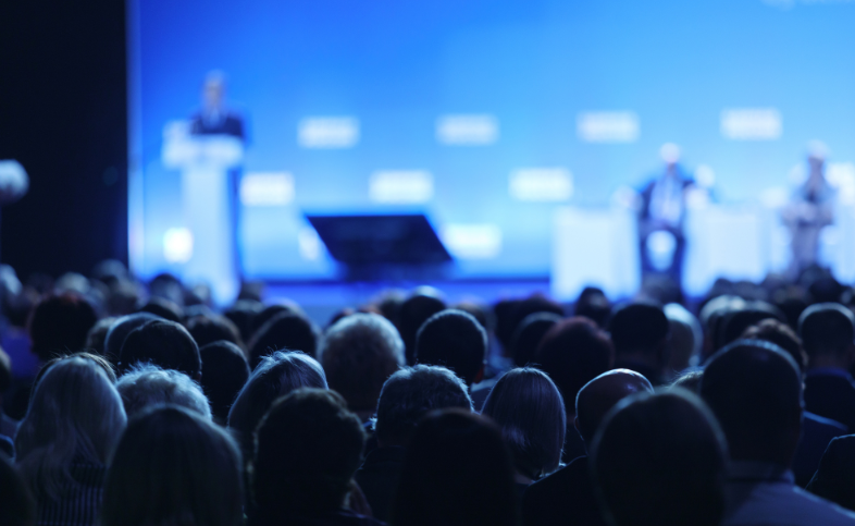 Audience listening to someone presenting