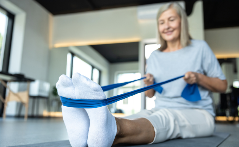 Women uses resistance band around feet