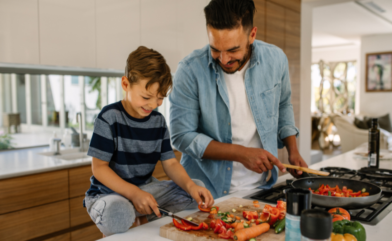 Family cooking together - chopping lots of vegetables